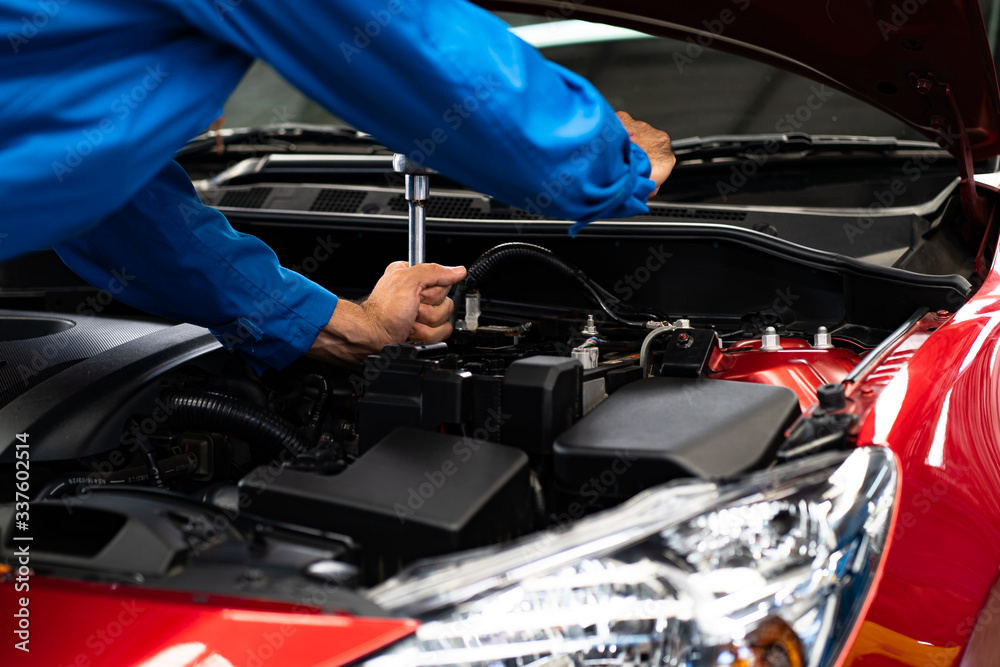 Hands of car mechanic in auto repair service.Car Mechanic Detailed Vehicle Inspection. Auto Service Center Theme. 