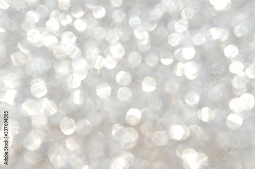 The bokeh of the patterned surface of the silver glitter plate.