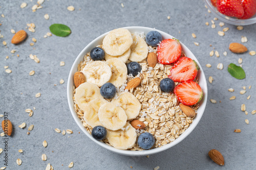 Healthy Breakfast oatmeal with fruit, berries and nuts.