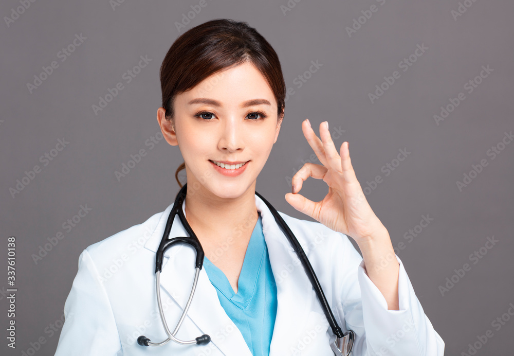 Smiling asian female doctor hand with ok sign Smiling asian female doctor hand with ok sign