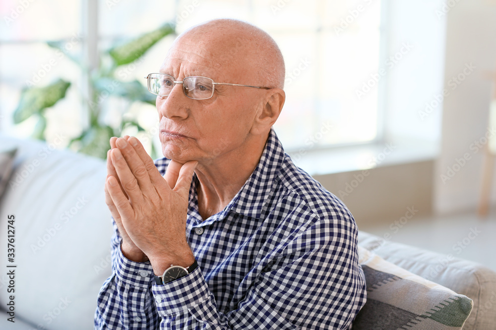 Portrait of praying elderly man at home Portrait of praying elderly man at home