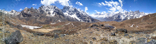 Panoramic view of Kyajo Ri mountain peak (6151 meters) in Himalayas in Nepal near Lunden village and Renjo La Pass. White clouds begin to gather over the mountain valley. Beautiful landscape.