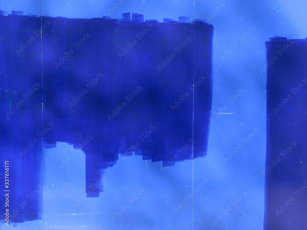 Fotografie blue paint on a lighter blue painted wall