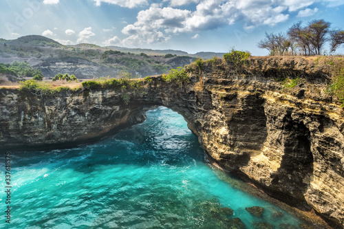Magnificent view of unique natural rocks and cliffs formation in beautiful beach known as Angel's Billabong beach located in the east side of Nusa Penida Island, Bali, Indonesia. Aerial view.