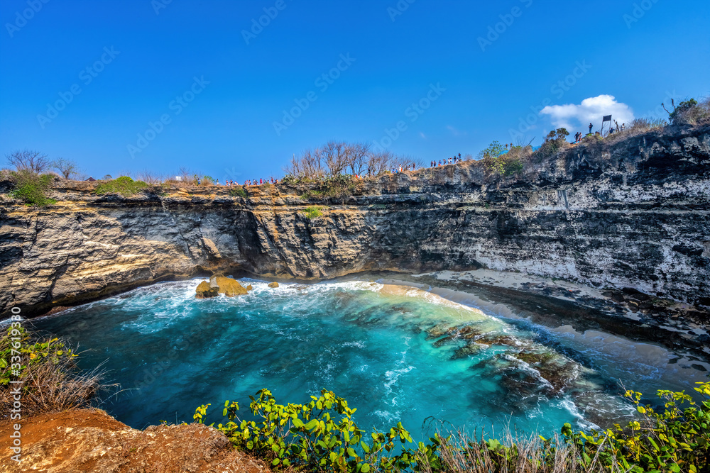 Magnificent view of unique natural rocks and cliffs formation in beautiful beach known as Angel's Billabong beach located in the east side of Nusa Penida Island, Bali, Indonesia. Aerial view.