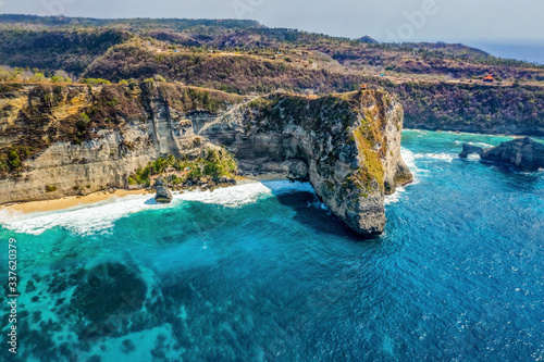 Magnificent view of unique natural rocks and cliffs formation in beautiful beach known as Atuh Beach located in the east side of Nusa Penida Island, Bali, Indonesia. Aerial view.