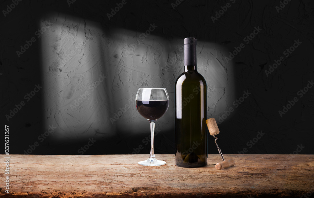Wine bottles with glass, wooden background border