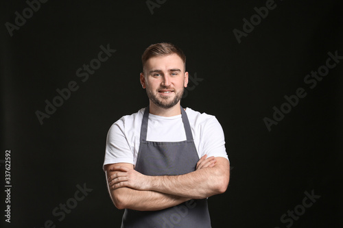 Handsome male chef on dark ...