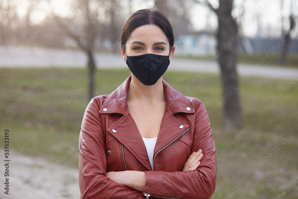 Horizontal shot of charming woman posing outdoor, female breathing