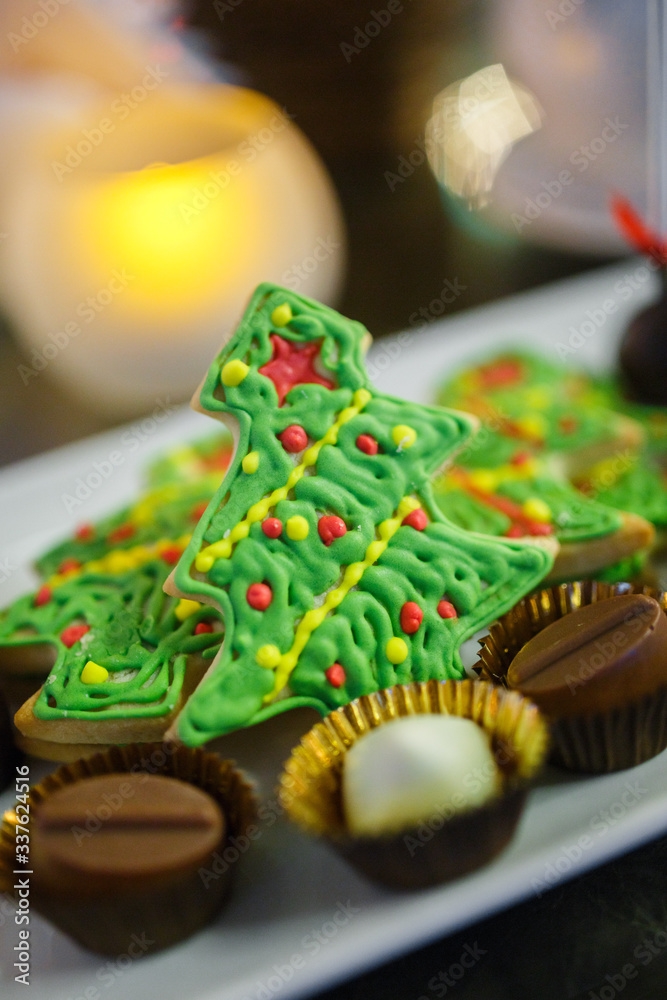 Gingerbread cookies in the form of a christmas tree with chocolate candies on a plate
