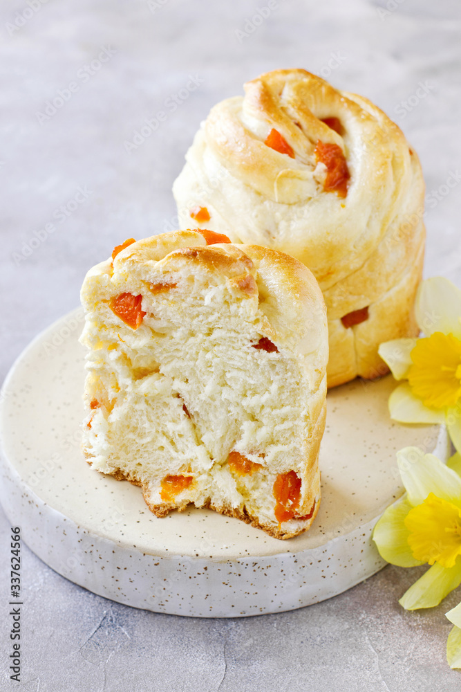 Easter cake Cuffin with dried apricots on white plate Easter cake Cuffin with dried apricots on white plate
