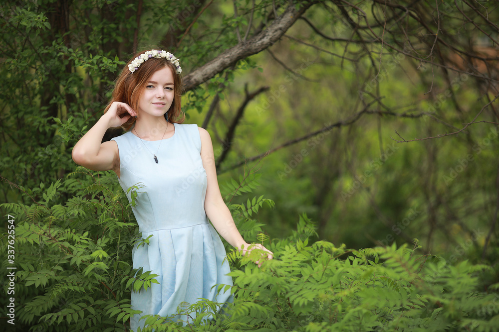 Girl in blue dress in green park Girl in blue dress in green park
