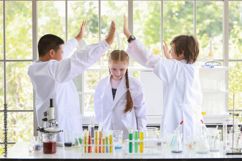 victory posting symbol of happy kids making science experiments. (success education or scientist concept) victory posting symbol of happy kids making science experiments. (success education or scientist concept)