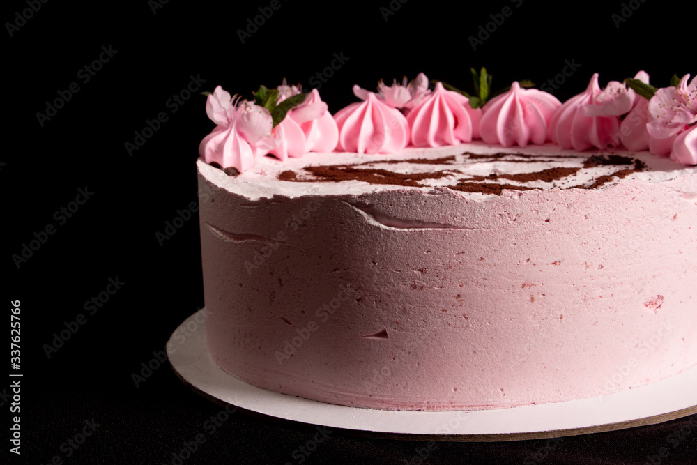 Pink marshmallow cake on a black background with a painted machine Pink marshmallow cake on a black background with a painted machine
