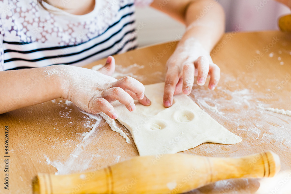 the girl helps her mother in the kitchen, makes pastry from dough, dough, rolling pin, flour, baking, cooking from dough and flour, Breakfast