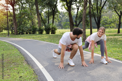 a runner caucasian couple is at starter for jogging in the park during summer season with smile (healthy or sport concept)