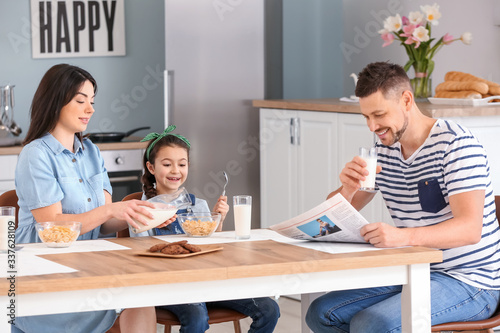 Family drinking milk during breakfast at home