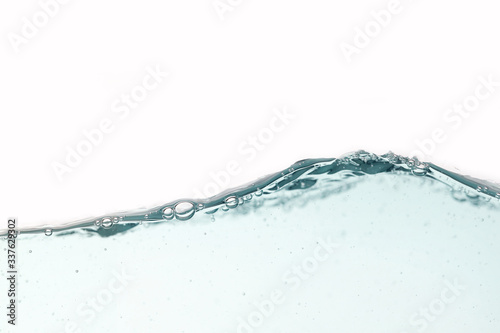 Close up blue water splash with air bubbles on white background isolated. Advertising image with free space for your work .