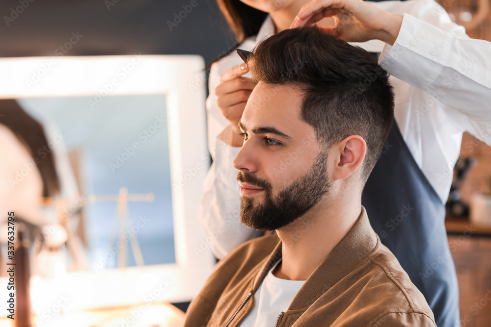 Fototapeta premium Hairdresser working with client in salon