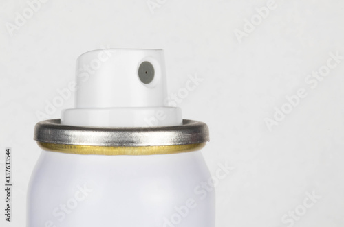 Nozzel on the top of an aerosol cannister.  Isolated close up on a white background