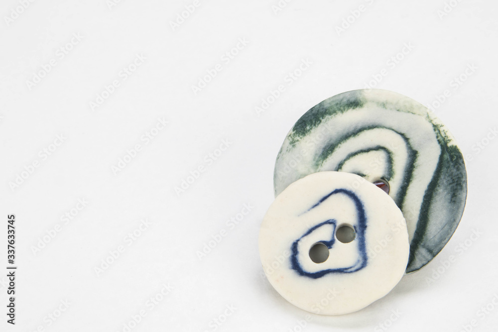 Selection of artisan handmade ceramic buttons isolated on a white background. Close up macro Selection of artisan handmade ceramic buttons isolated on a white background. Close up macro