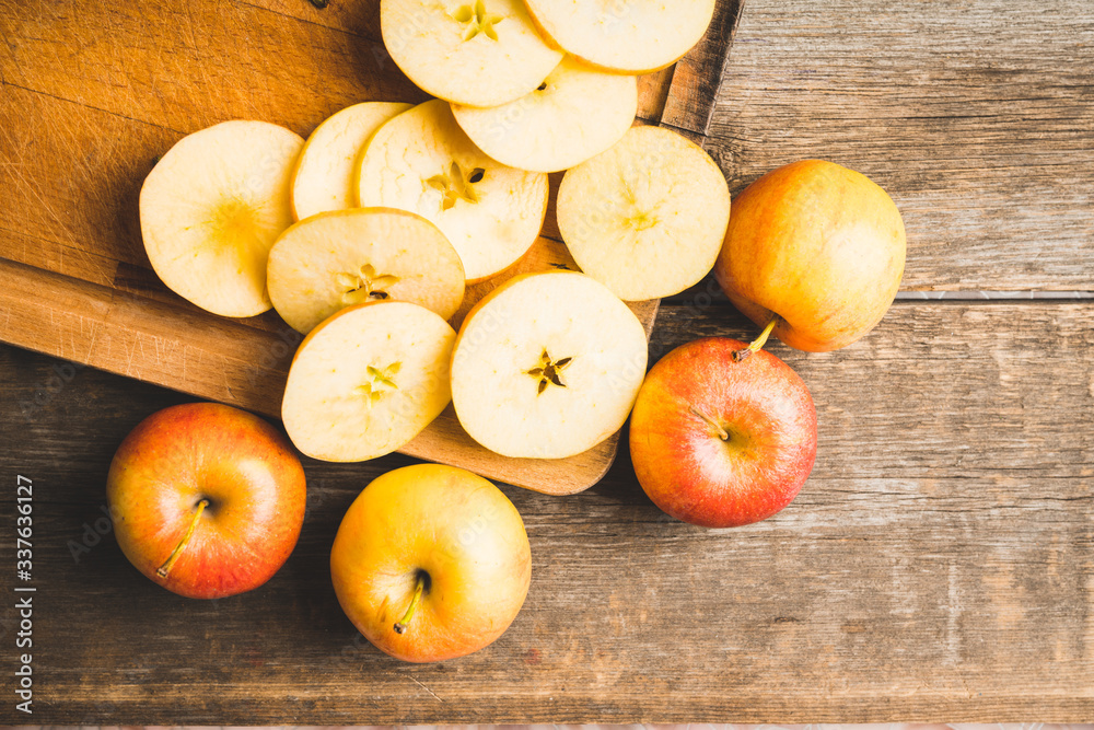 Freshly harvested ripe apple on the rustic wooden background. Selective focus. Shallow depth of field. Freshly harvested ripe apple on the rustic wooden background. Selective focus. Shallow depth of field.