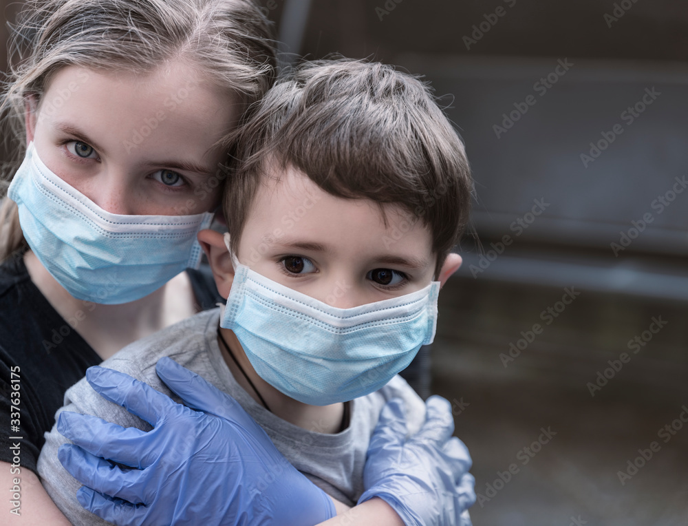 Bored Caucasian Children wearing cloth face masks against coronavirus pandemic. Quarantine Concept