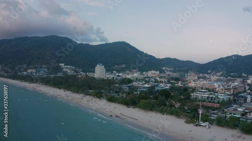 Open view of Patong  beach with numerous tourists and hotel buildings in background in the evening, Phuket, Thailand photo
