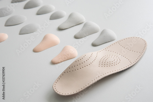 Orthopedic insole on a white background. Treatment and prevention of flat feet and foot diseases. Foot care, foot comfort. Wear comfortable shoes.