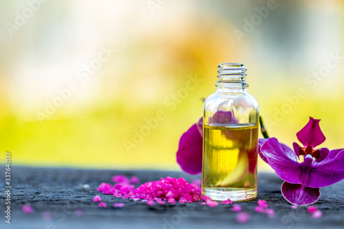 Essential oils and medical flowers herbs on bokeh background.