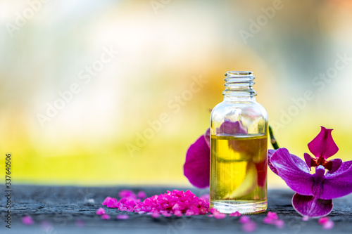 Essential oils and medical flowers herbs on bokeh background.