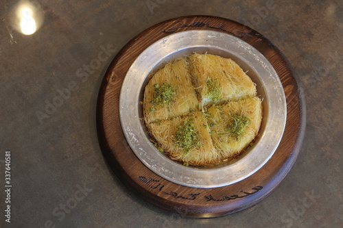 A slice piece of Esmalliyeh Arabic sweets & Ramadan dessert in a white sweet cream