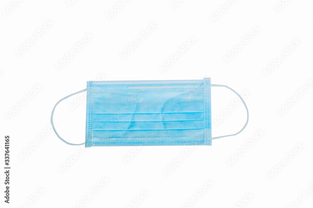 Surgical mask with rubber ear straps. Typical 3-ply surgical mask to cover the mouth and nose. Procedure mask from bacteria. Protection concept.. Surgical mask with rubber ear straps. Typical 3-ply surgical mask to cover the mouth and nose. Procedure mask from bacteria. Protection concept..
