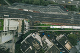 Aerial drone overhead view of Chongqing light rail carriage on rail to Liziba transit along residential buildings on the street