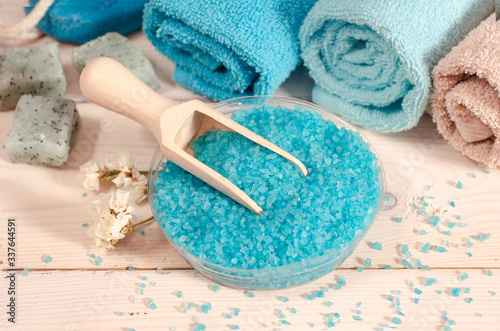 spa wellness cosmetic organic products sea salt. Sea salt, towels and flowers on yellow background. Selective focus. Flat lay with copy space. © Iryna  Ustynchenko