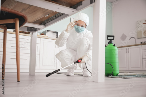 Worker in biohazard suit di...