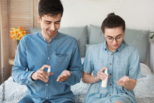 Couple applying disinfectan...