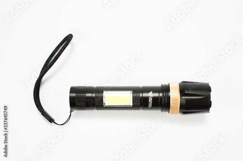 modern black metal flashlight isolated on white background