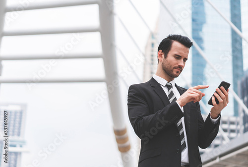 Business caucasian men present lifestyle at workplace outdoors. Businessman holding smart phone social distance online. Concept of business communication, remote conference and technology digital.