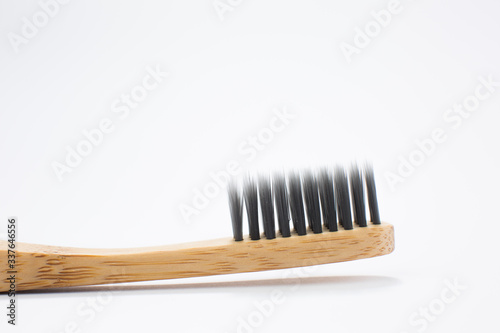 Toothbrush made of bamboo on white background, top view