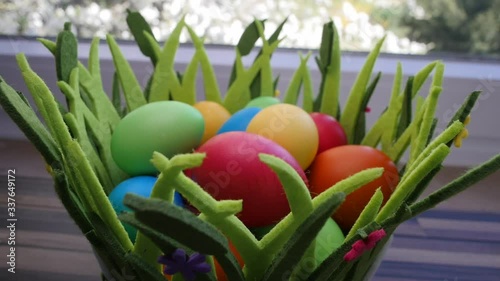 Colorful Easter eggs in a beautiful basket by the kitchen window.