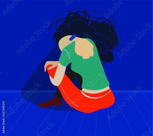 Depressed woman sits and hugs her knees facing the wall. Psychological problem, depression, people under stress. 
