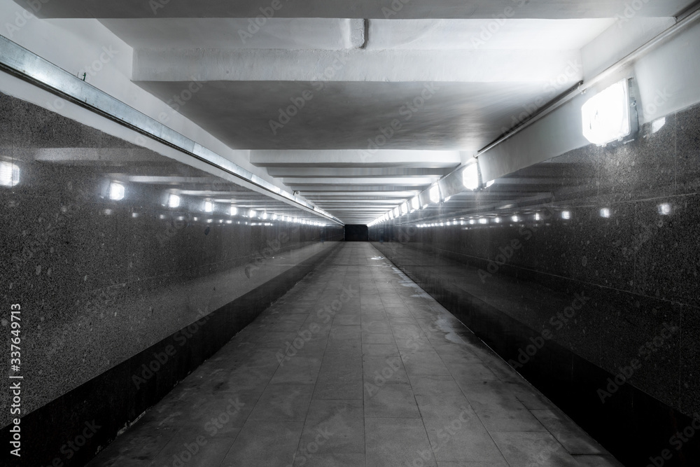 Underground pedestrian crossing. A long concrete tunnel in the city underground. Underpass. underground passage.
