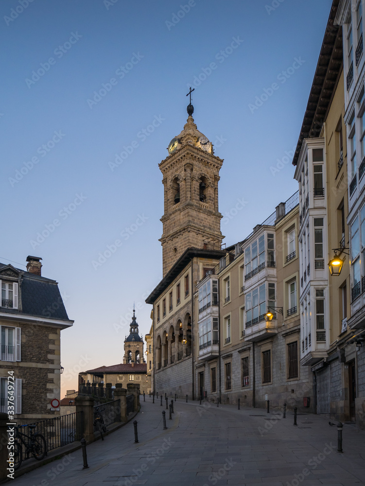 View of the tower of St. Vincent Church and Cuesta de San Vicente Street, in the back the tower of St. Michael Church in Vitoria-Gasteiz, Spain