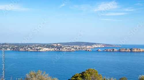 aerial view over Rocks, cliffs, island and sea water during sunset from the view point cap andritxol in Camp de Mar, Majorca island, Spain photo