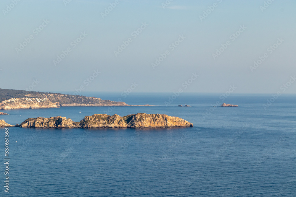 aerial view over Rocks, cliffs, island and sea water during sunset from the view point cap andritxol in Camp de Mar, Majorca island, Spain