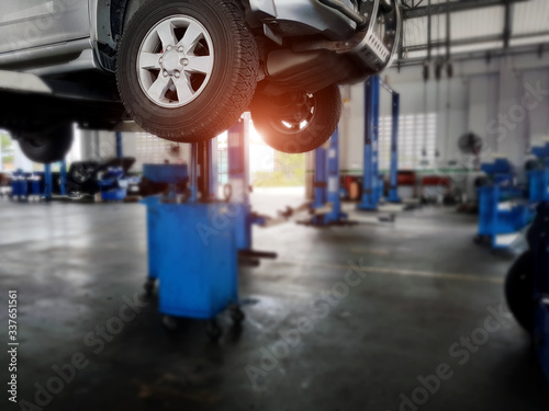 Service in auto repair station, Blurred background : Car technician repairing the car in the shop