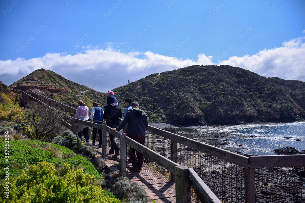 People are at coast of the sea with clear blue sky background in Australia