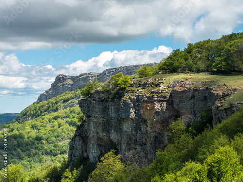 Landscape of the Entzia mountain range, beech woodland, cliffs, habitat of vultures and section of the Sendero del Pastoreo hiking trail (shepherd's trail), near Opakua, Alava, Basque Country, Spain