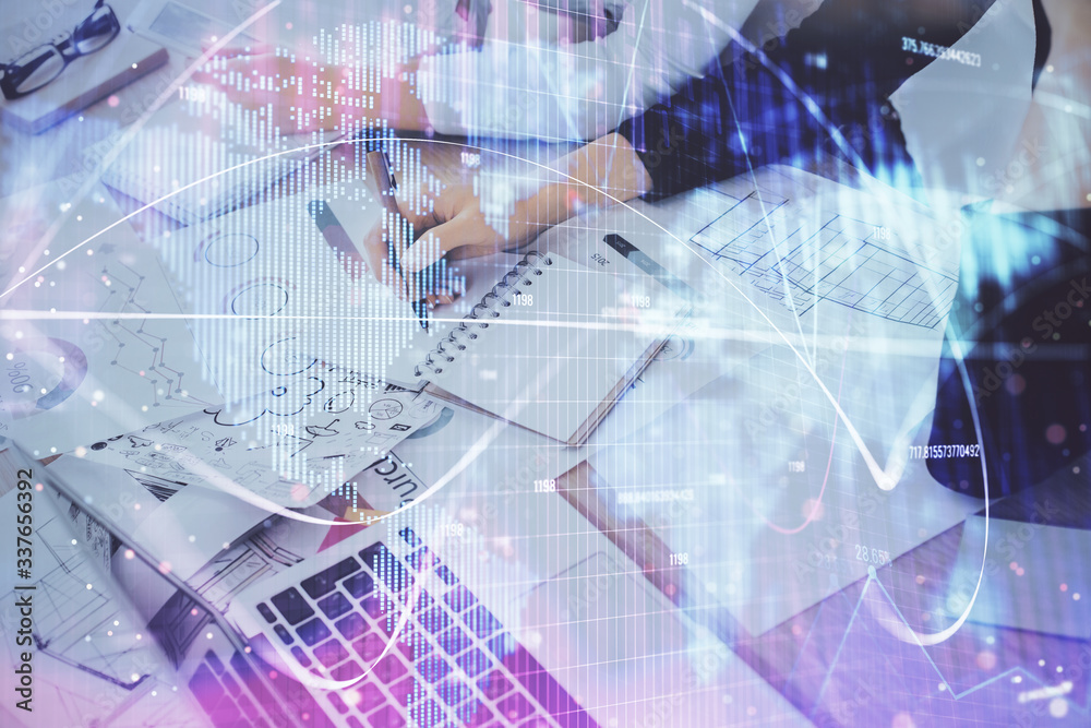 International business hologram over hands taking notes background. Concept of success. Multi exposure International business hologram over hands taking notes background. Concept of success. Multi exposure